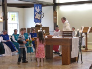 Children of the congregation bring the gifts of bread and wine to the Altar.