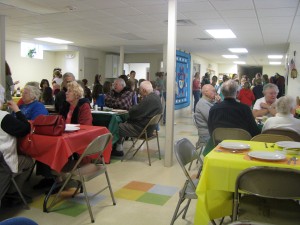 Weare seniors enjoy a holiday meal served by the Girl Scouts in the Parish Hall.