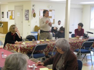 Caroline Fairless (left) listens as Jim Sims talks about their ministry over Sunday morning breakfast.