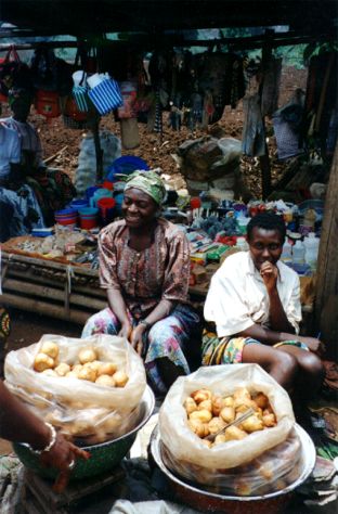 KWIHEED supports microentrepreneurs like this woman, selling produce in the marketplace.